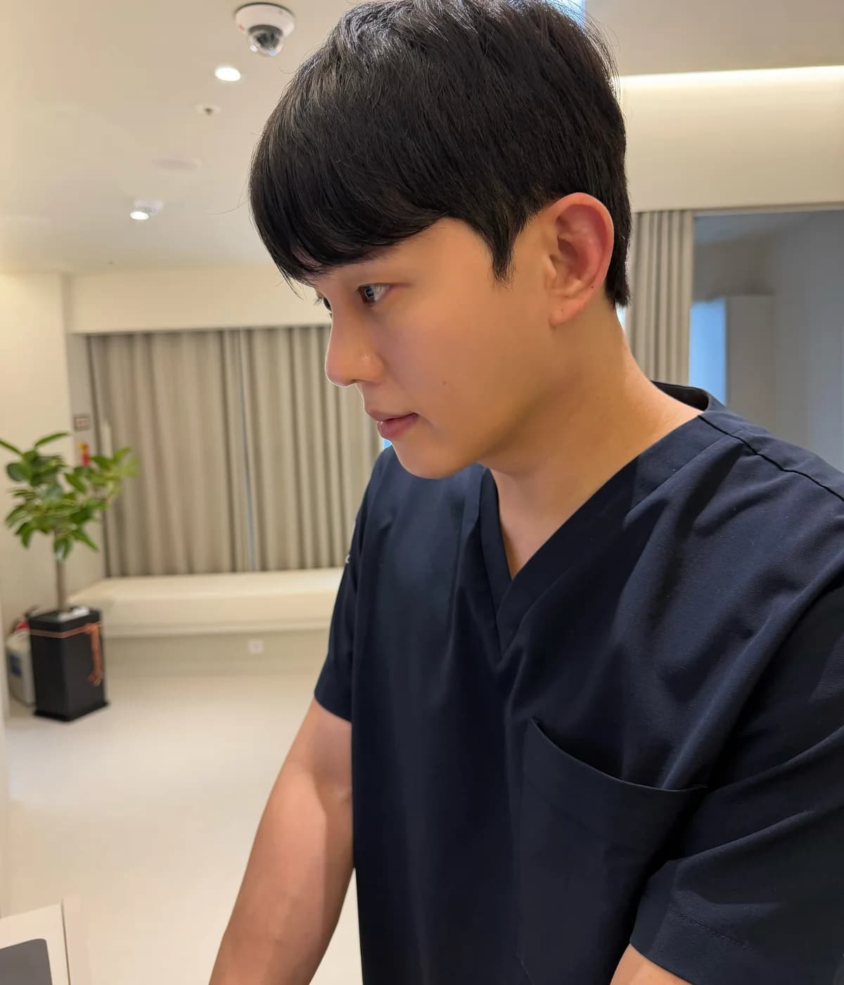 Doctor preparing a consultation review inside a Seoul aesthetic clinic